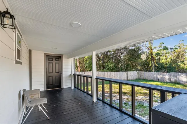 a view of a porch with wooden floor and outdoor space
