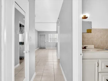 a view of a hallway with washer and dryer