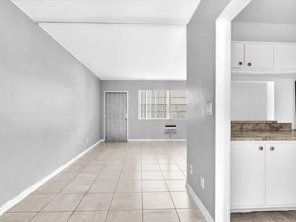 a view of a kitchen with an empty space and window