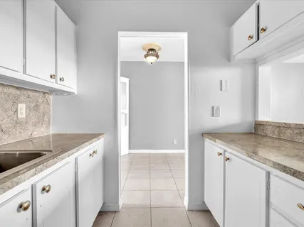 a kitchen with a sink and cabinets
