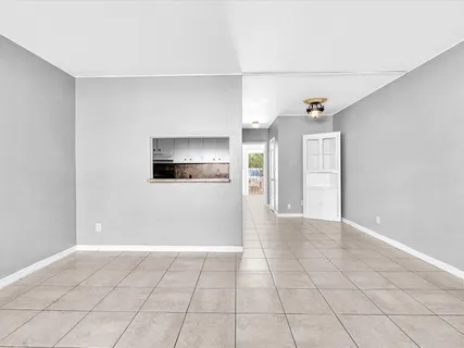 a view of a livingroom with an empty space and a window