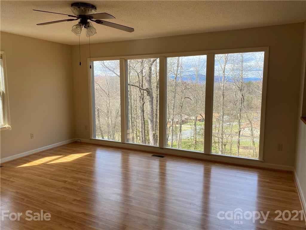 126 Burma Road West Marion, NC 28752 - Photo 14 of 29 a view of an empty room with wooden floor and a window