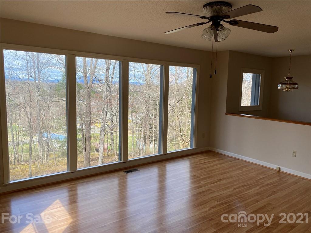 126 Burma Road West Marion, NC 28752 - Photo 15 of 29 a view of an empty room with wooden floor and a window