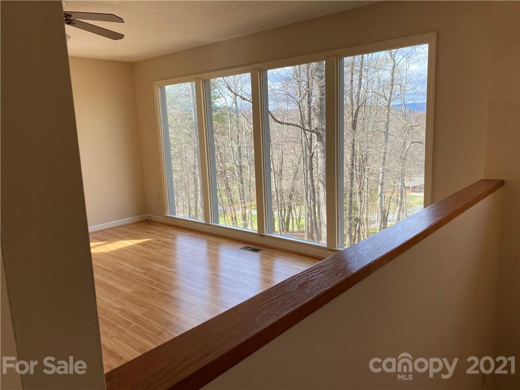 126 Burma Road West Marion, NC 28752 - Photo 17 of 29 a view of an empty room with wooden floor and a window
