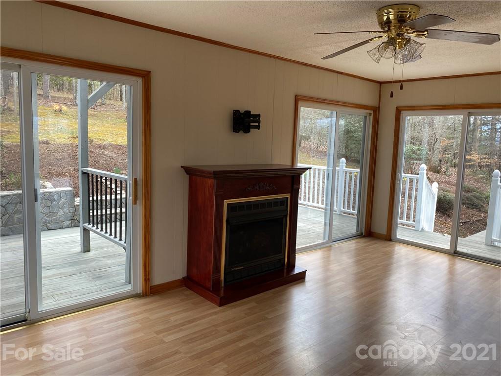 126 Burma Road West Marion, NC 28752 - Photo 20 of 29 a view of a livingroom with wooden floor and a fireplace