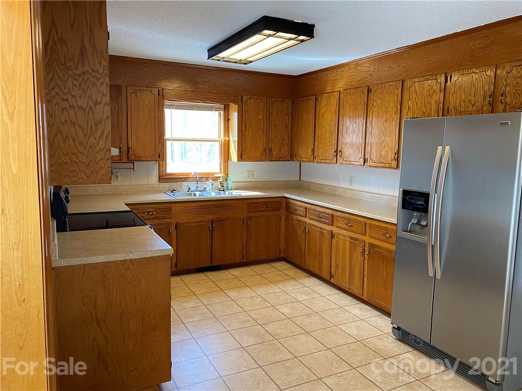 126 Burma Road West Marion, NC 28752 - Photo 24 of 29 a kitchen with stainless steel appliances granite countertop a sink stove and refrigerator