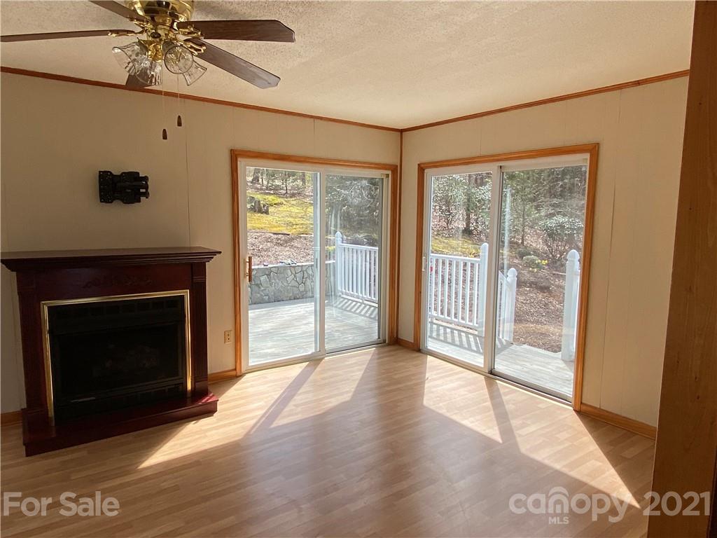 126 Burma Road West Marion, NC 28752 - Photo 29 of 29 a view of an empty room with wooden floor and a fireplace