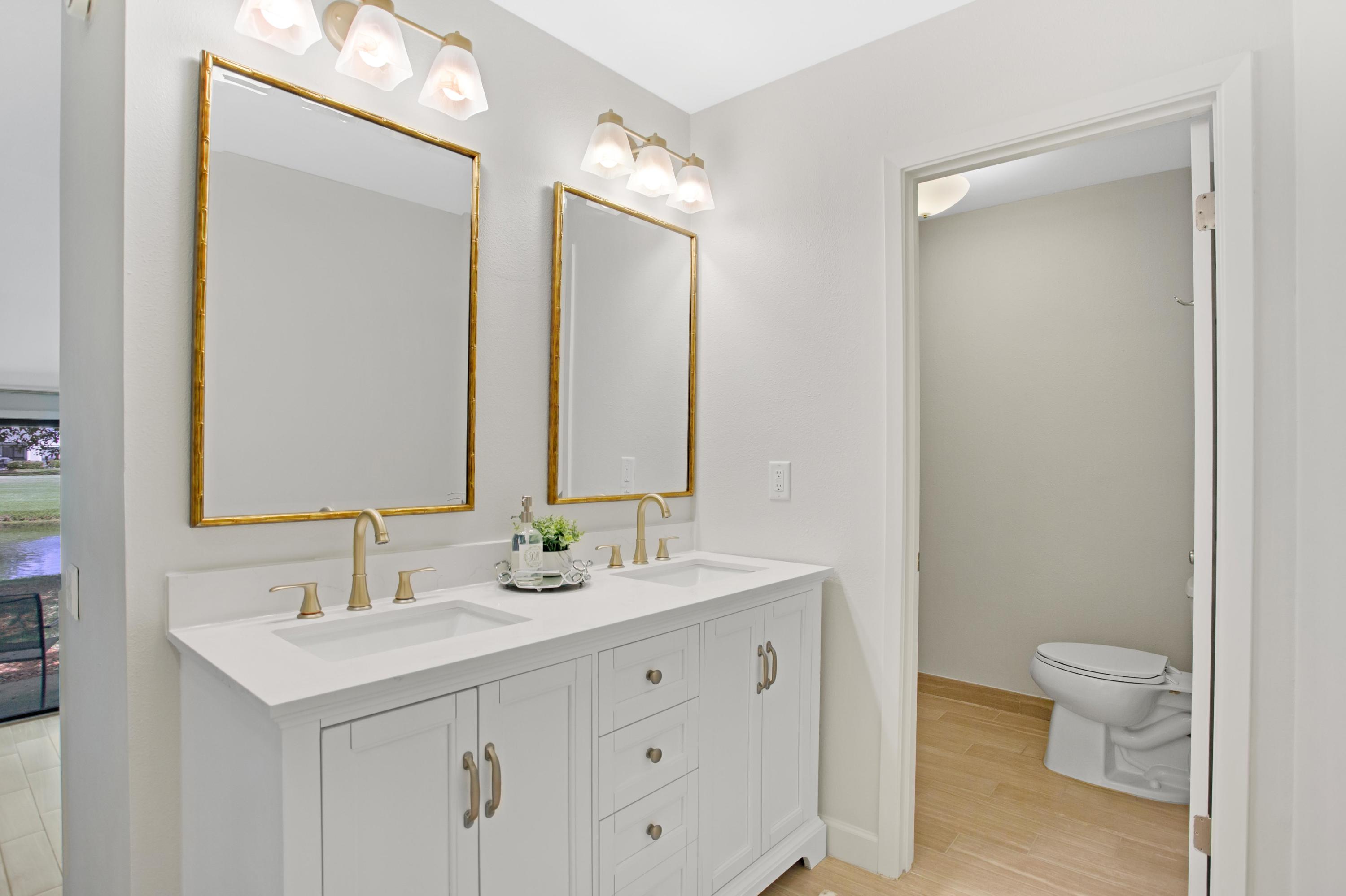 666 Bayou Drive, Unit 666 Miramar Beach, FL 32550 - Photo 17 of 24 a bathroom with a sink a toilet and a mirror