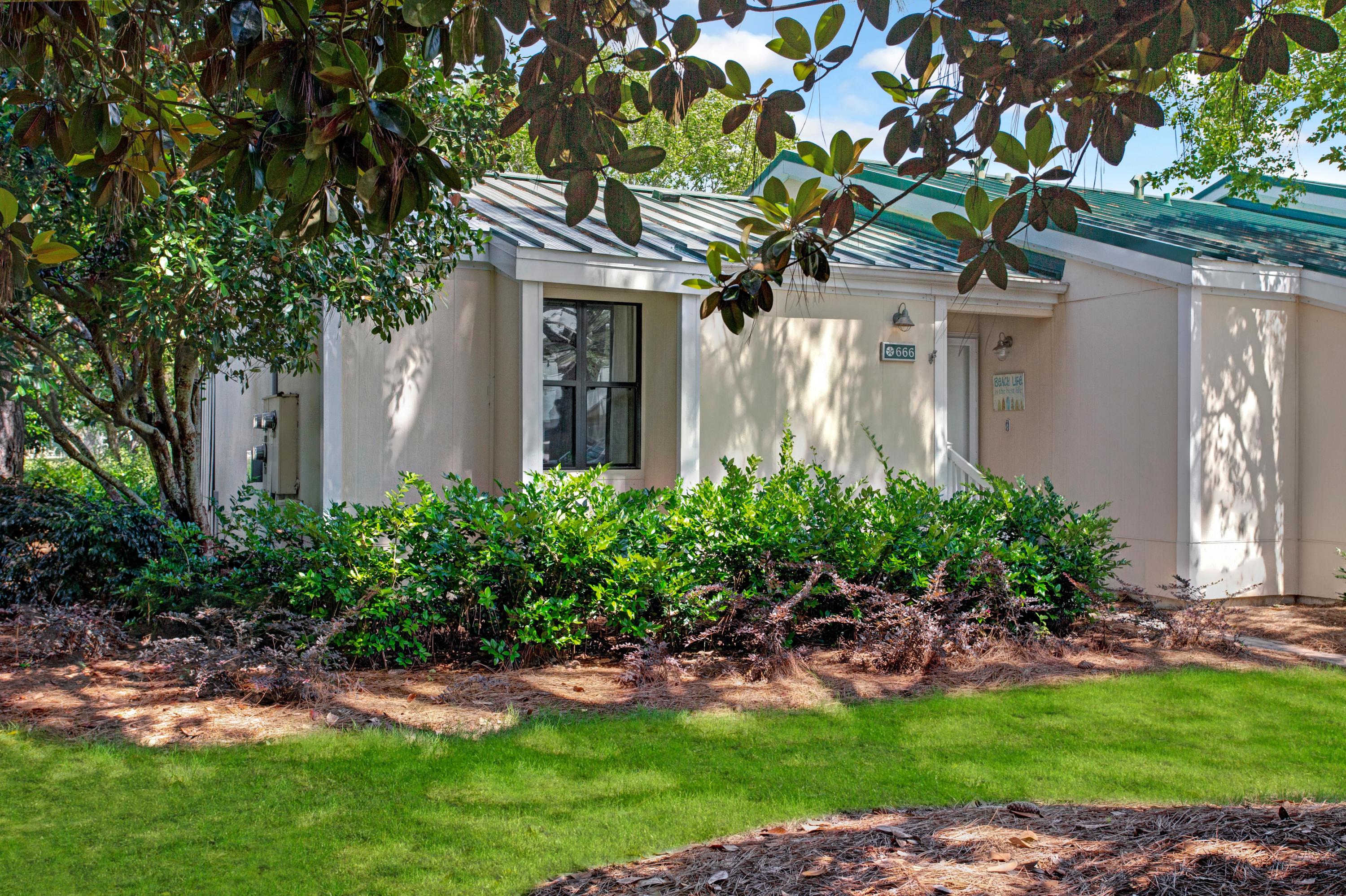 666 Bayou Drive, Unit 666 Miramar Beach, FL 32550 - Photo 2 of 24 a front view of a house with a garden