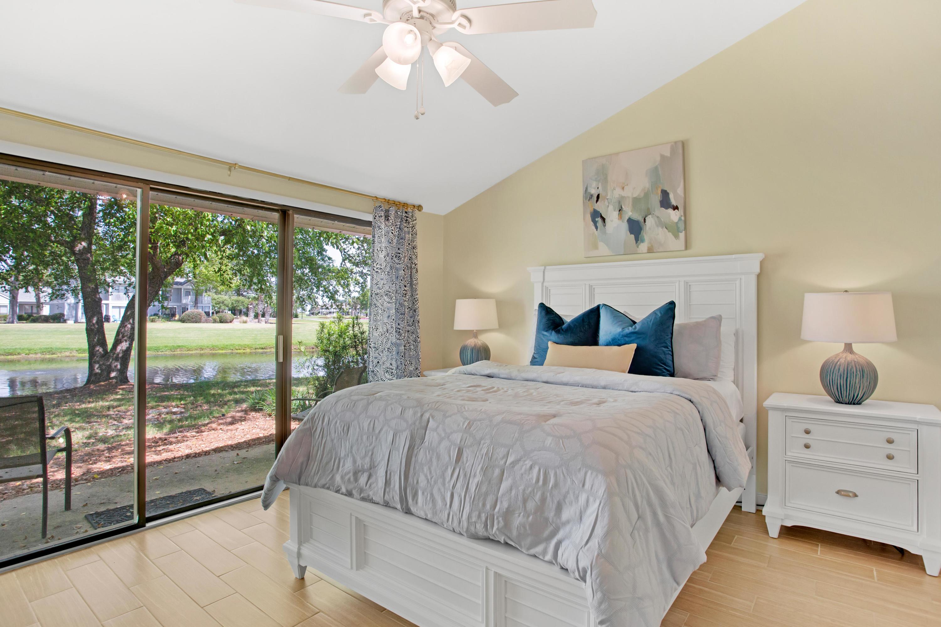 666 Bayou Drive, Unit 666 Miramar Beach, FL 32550 - Photo 21 of 24 a spacious bedroom with a large bed and a chandelier