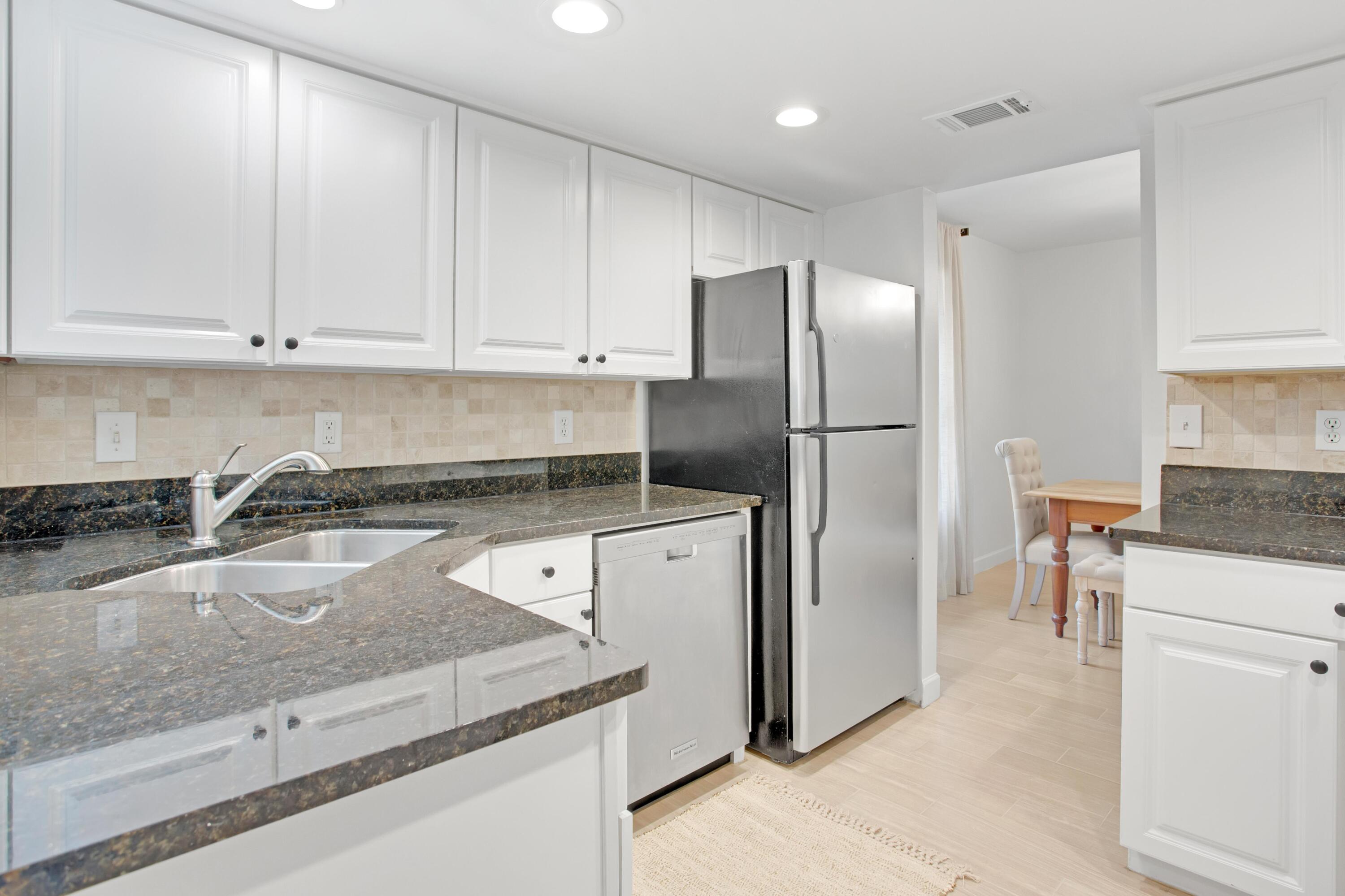 666 Bayou Drive, Unit 666 Miramar Beach, FL 32550 - Photo 10 of 24 a kitchen with a refrigerator sink and cabinets