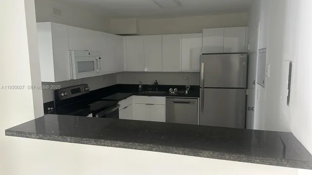 a kitchen with a refrigerator and a sink