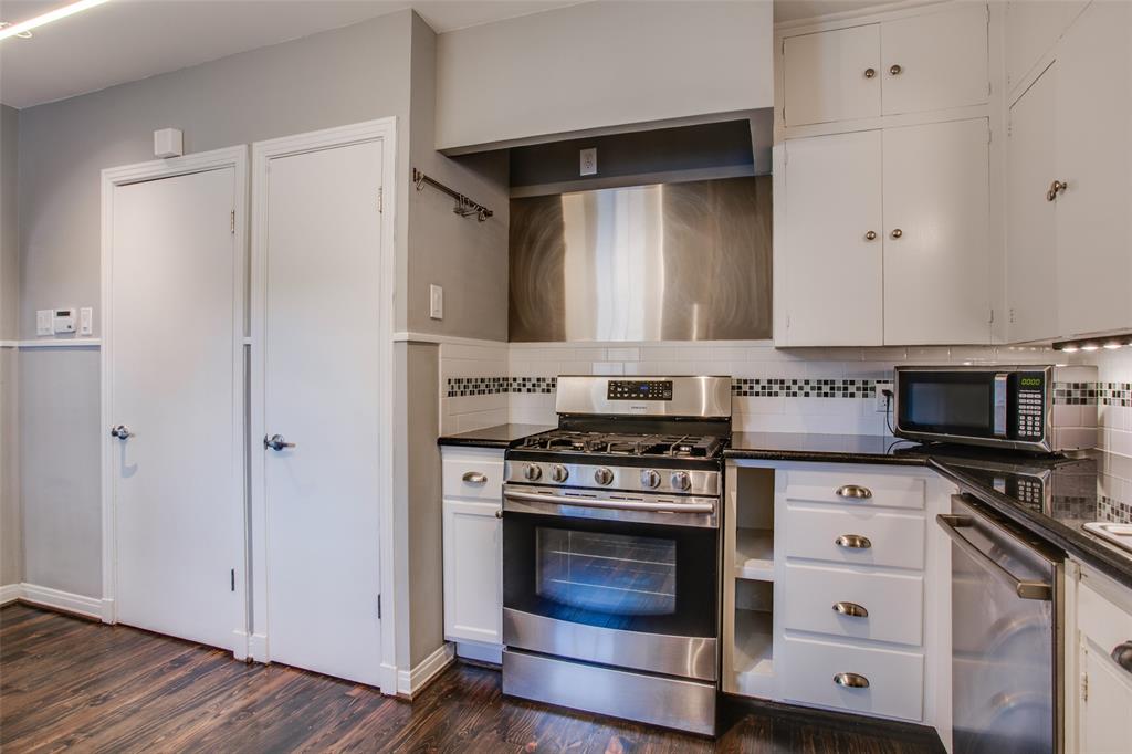 2051 Marydale Road Dallas, TX 75208 - Photo 17 of 30 a kitchen with stainless steel appliances granite countertop a stove and a microwave