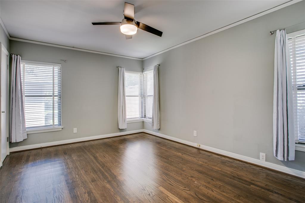 2051 Marydale Road Dallas, TX 75208 - Photo 21 of 30 an empty room with wooden floor and windows