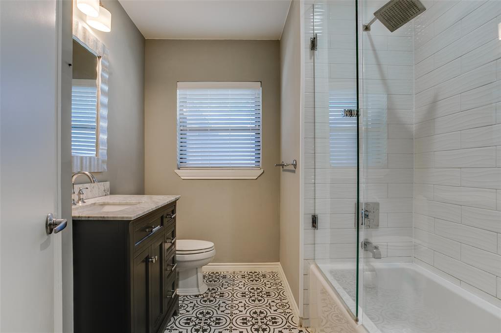 2051 Marydale Road Dallas, TX 75208 - Photo 22 of 30 a bathroom with a granite countertop sink a toilet and shower