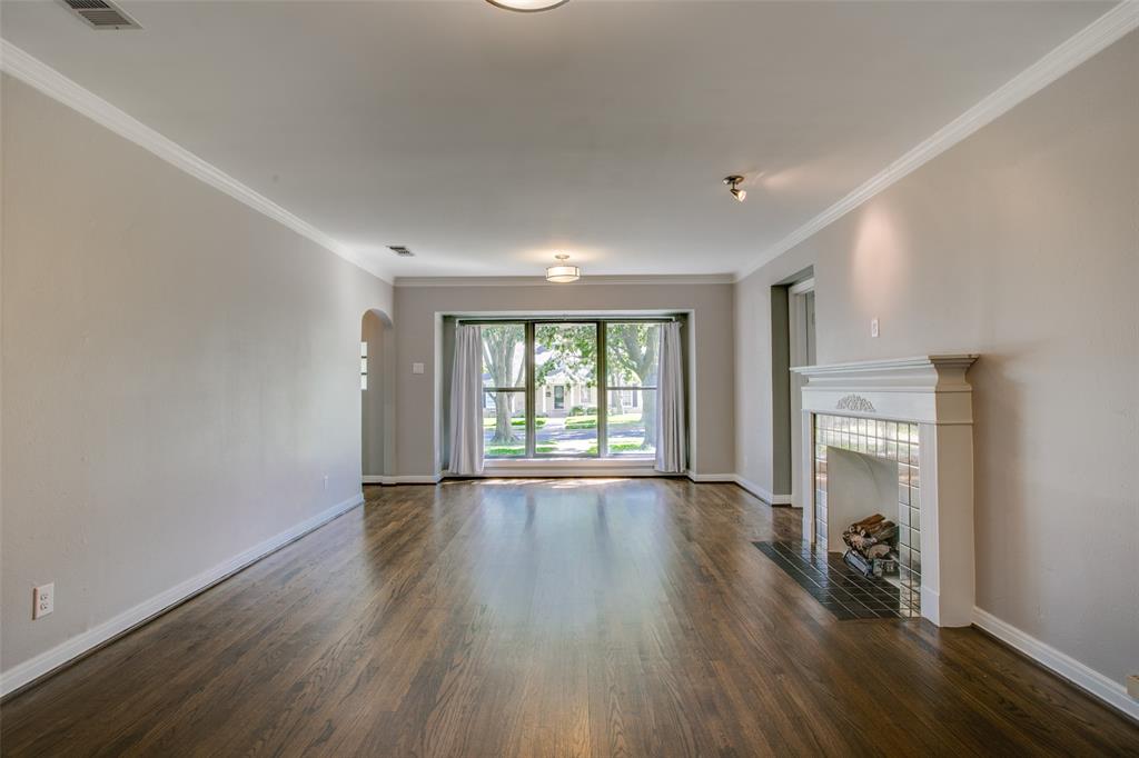 2051 Marydale Road Dallas, TX 75208 - Photo 7 of 30 a view of an empty room with window and wooden floor