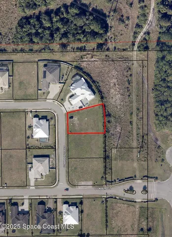 an aerial view of a brick building with glass windows