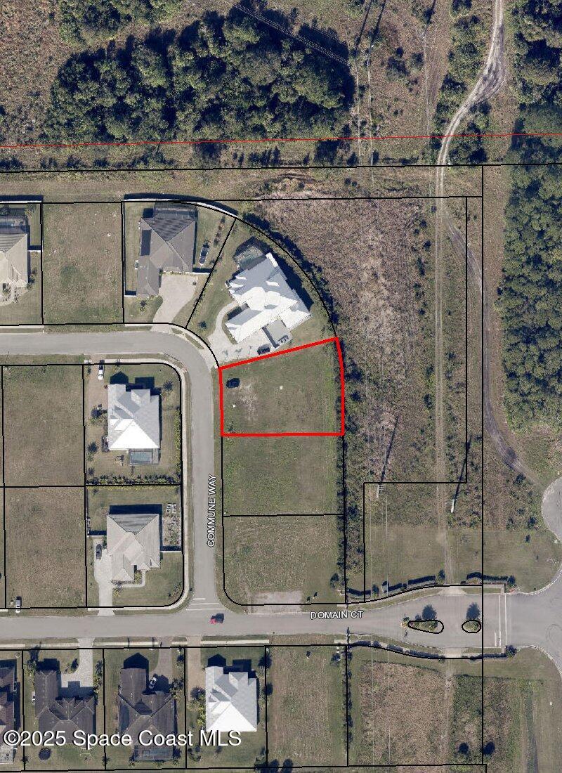 an aerial view of a brick building with glass windows