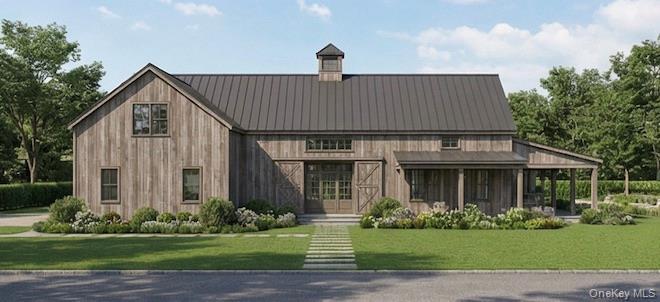 1000 Rocky Point Road East Marion, NY 11939 - Photo 9 of 14 a front view of a house with a garden