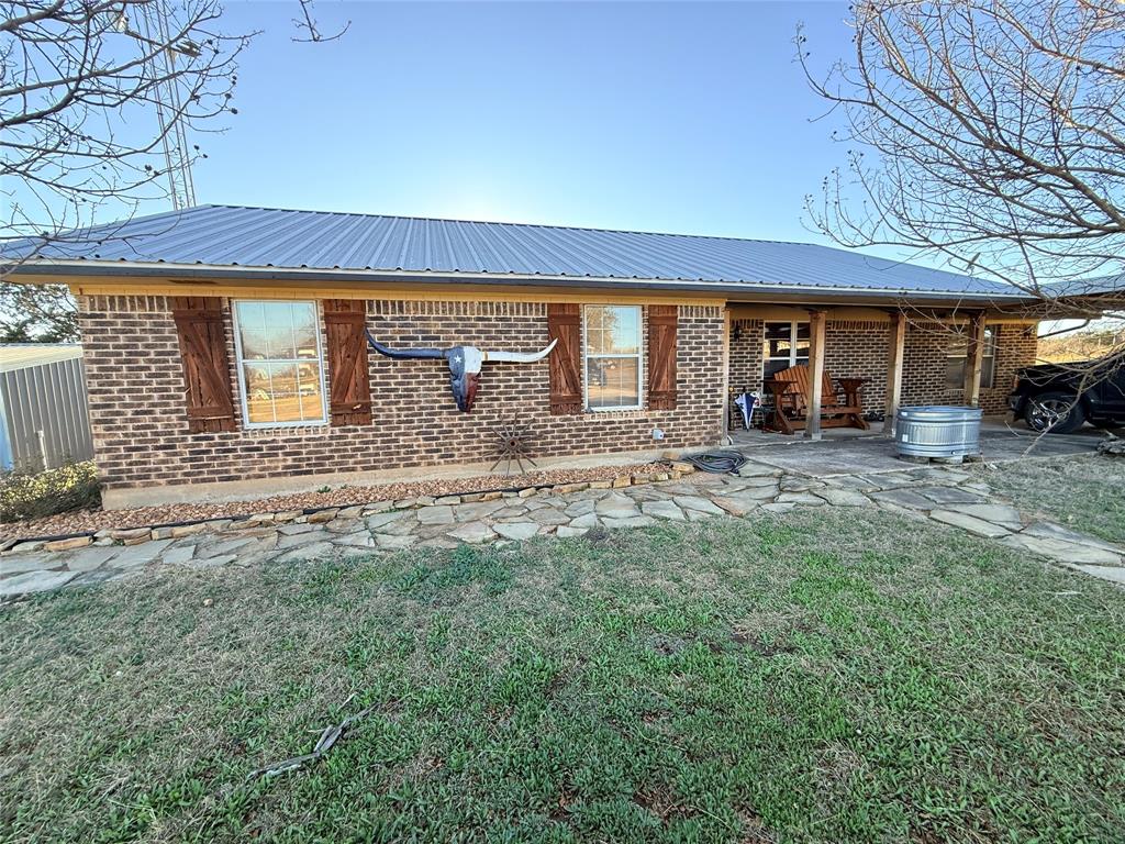 a view of a house with a backyard and porch