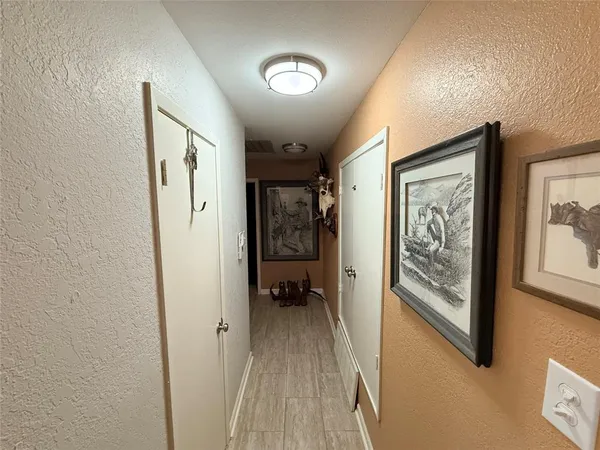 a view of a hallway to rooms and stairs
