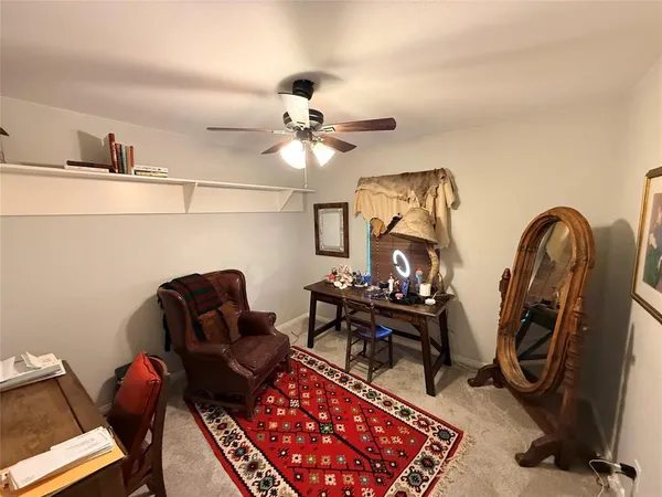 a living room with furniture a rug and a chandelier