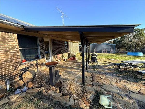 a view of a backyard with two chairs and a table