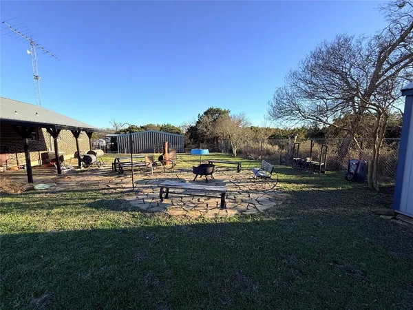 a swimming pool with outdoor seating and yard