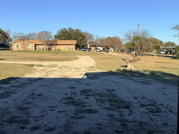 a view of a house with a backyard and garage