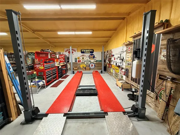 a gym room with furniture and gym equipment