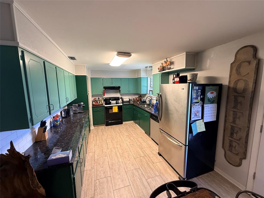 351 Bosque Bend Lane China Spring, TX 76633 - Photo 4 of 39 a kitchen with stainless steel appliances a refrigerator a sink a stove top oven a dining table and chairs