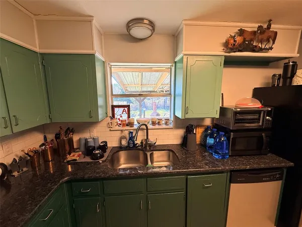 a kitchen with a sink and cabinets
