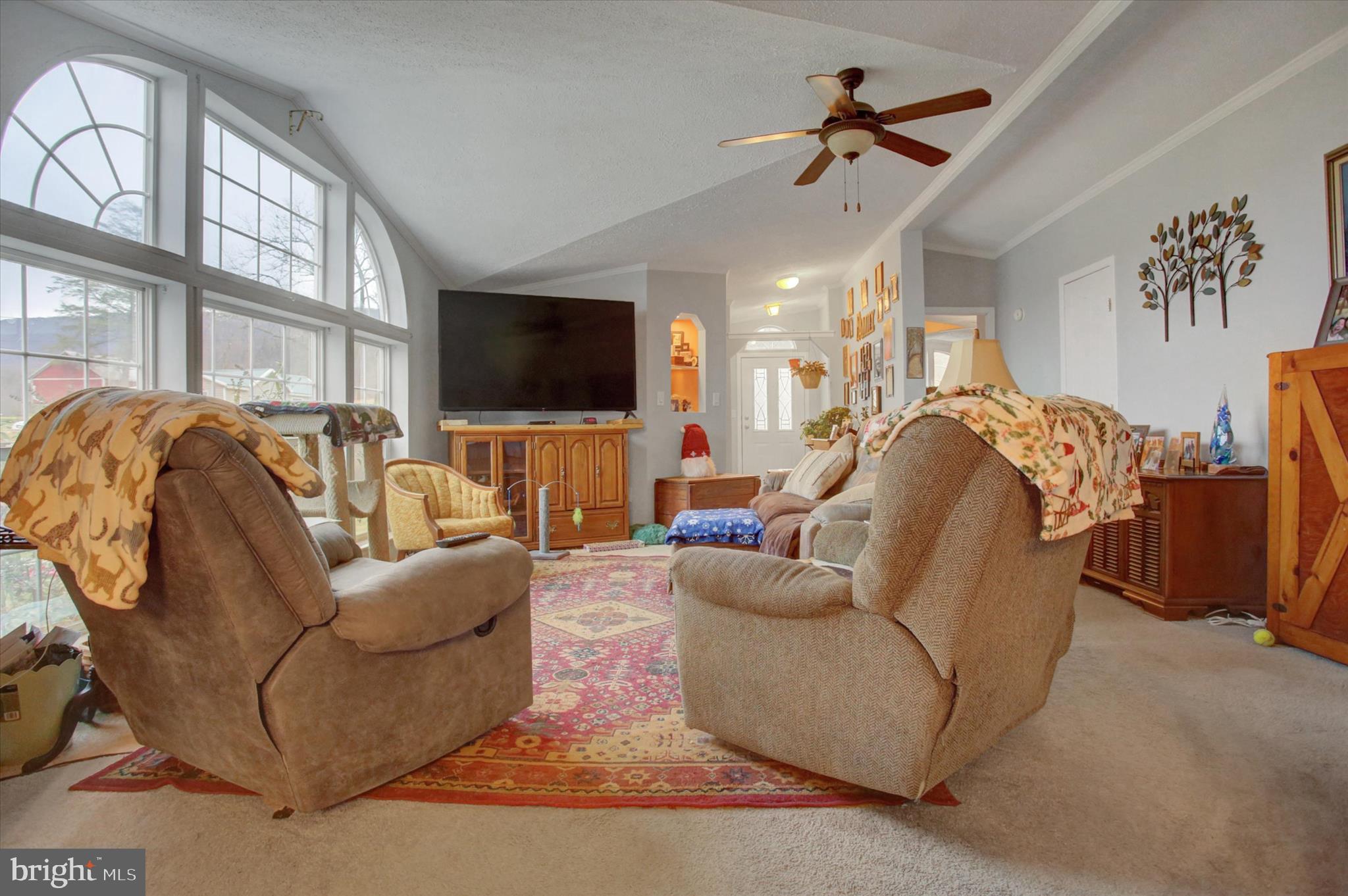 21571 Path Valley Road Dry Run, PA 17220 - Photo 12 of 63 a living room with furniture a flat screen tv and a chandelier
