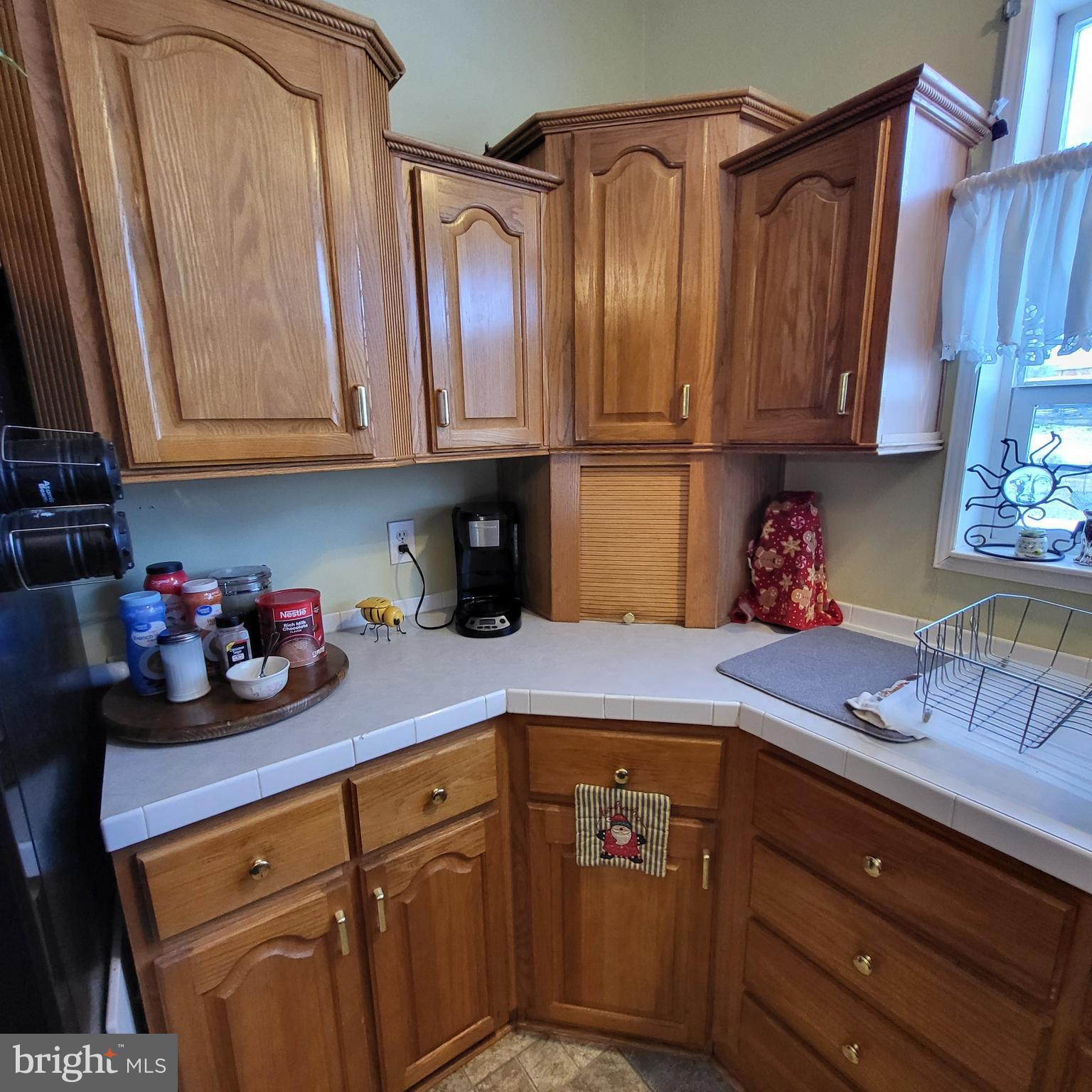 21571 Path Valley Road Dry Run, PA 17220 - Photo 19 of 63 a kitchen with stainless steel appliances granite countertop a sink refrigerator and cabinets