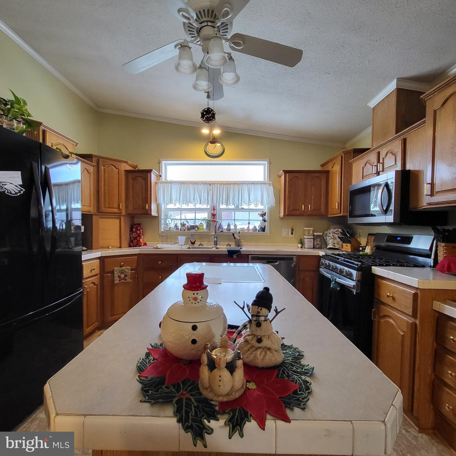 21571 Path Valley Road Dry Run, PA 17220 - Photo 22 of 63 a kitchen with a chandelier stainless steel appliances and cabinets