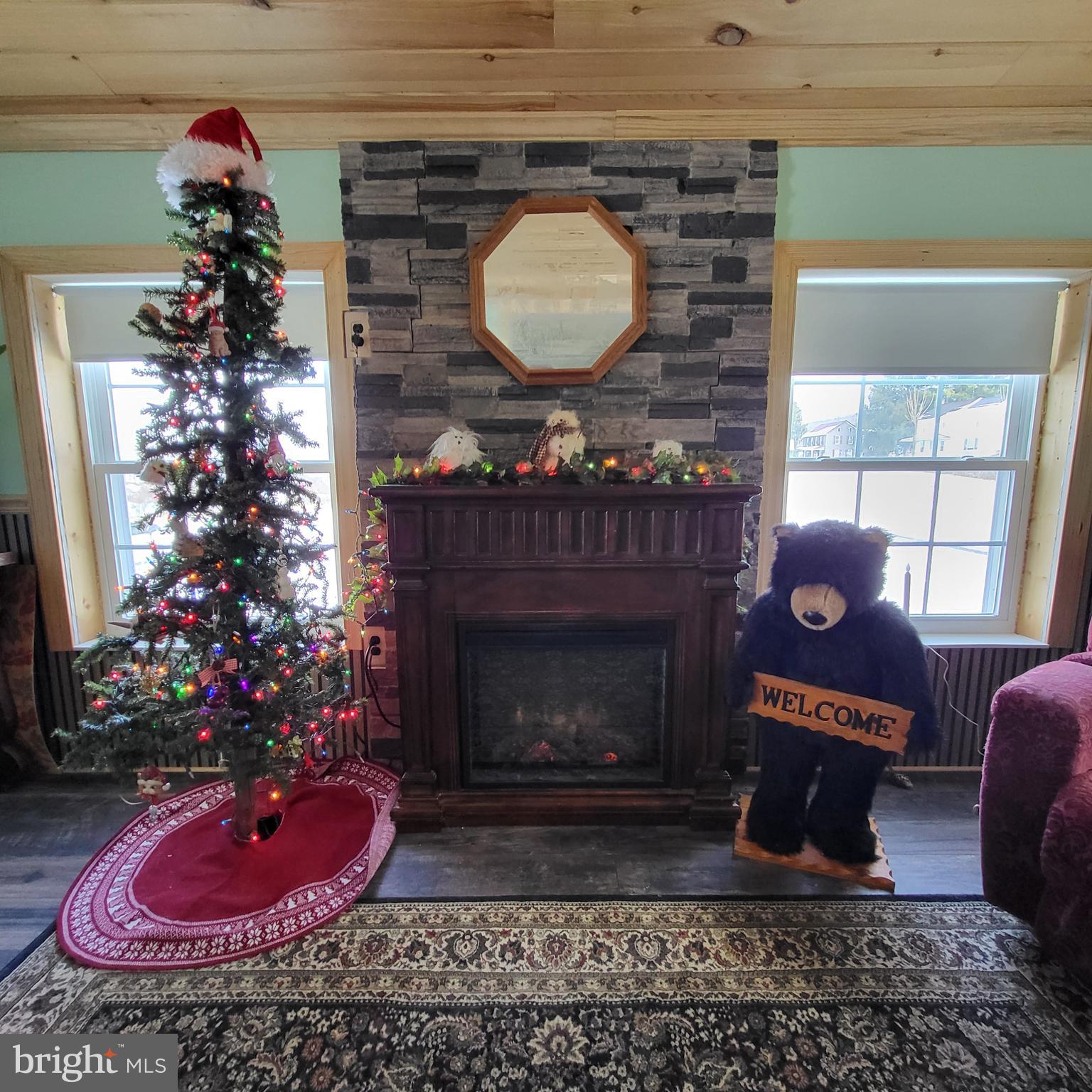 21571 Path Valley Road Dry Run, PA 17220 - Photo 28 of 63 a living room with a fireplace and flowers