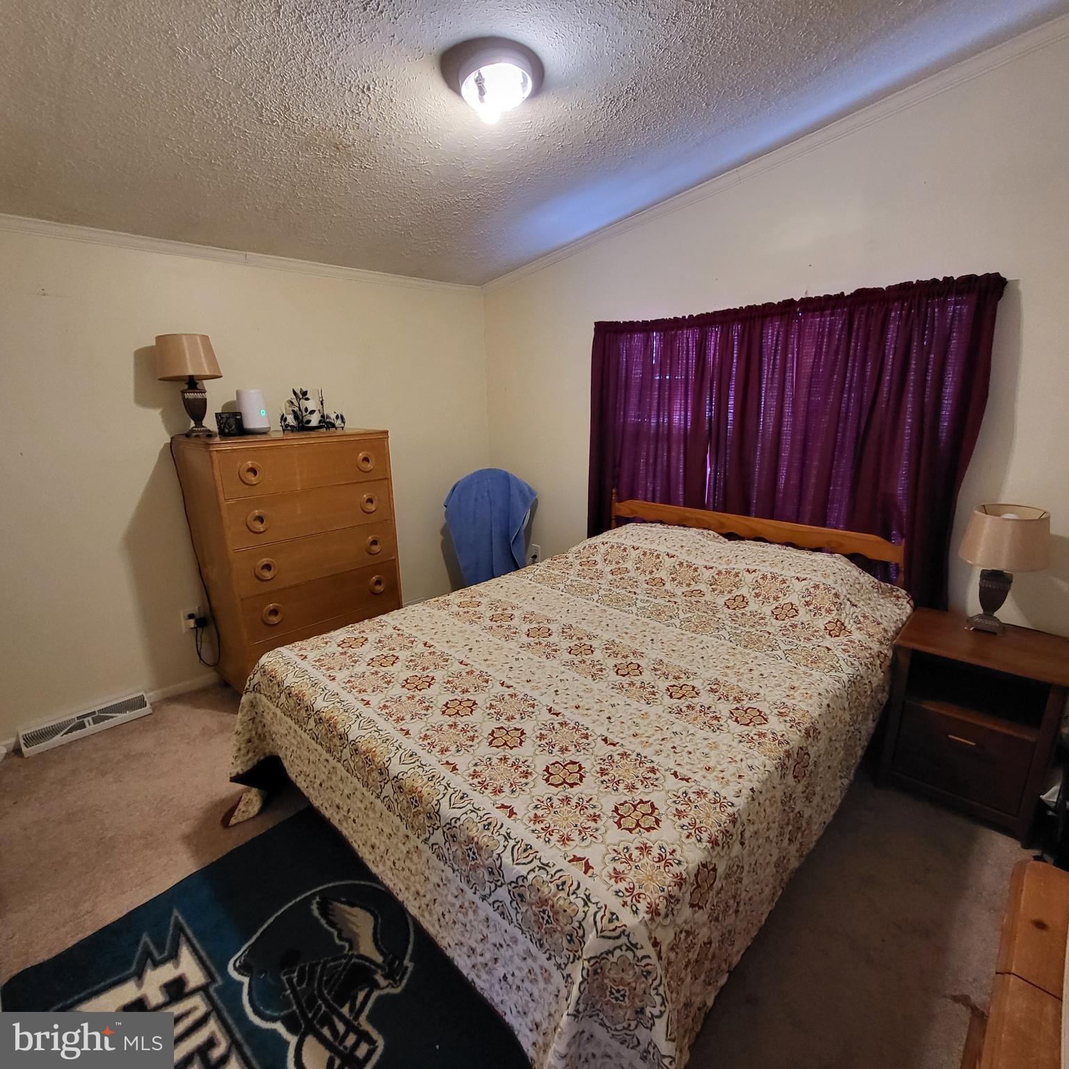 21571 Path Valley Road Dry Run, PA 17220 - Photo 35 of 63 a bed sitting in a bedroom next to a dresser with wooden floor
