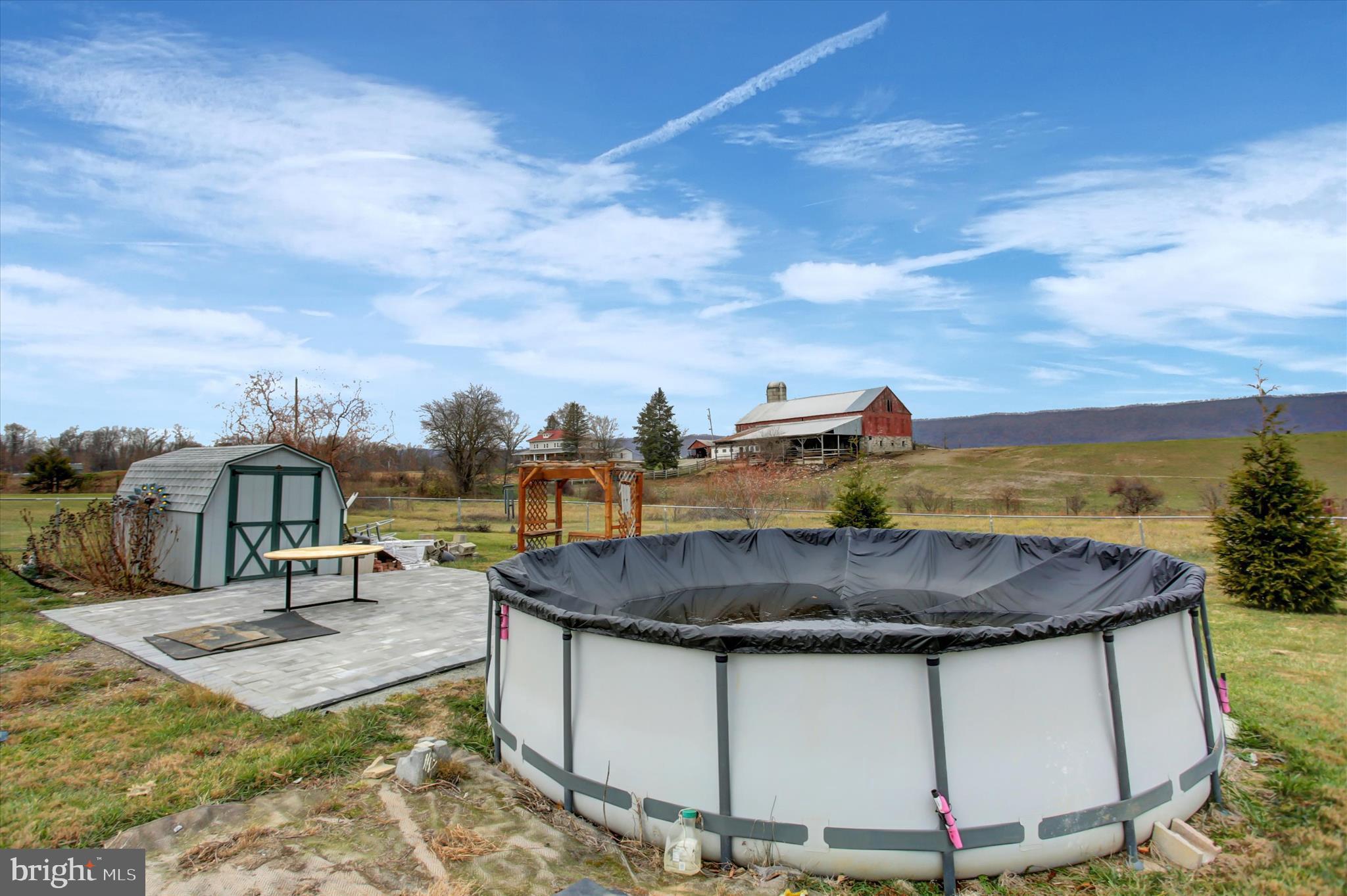 21571 Path Valley Road Dry Run, PA 17220 - Photo 56 of 63 a view of a swimming pool with a table and chairs
