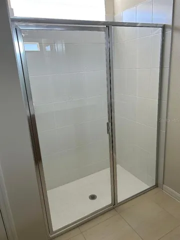 a bathroom with a glass shower door