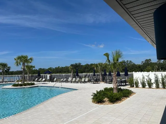 a view of swimming pool with outdoor seating