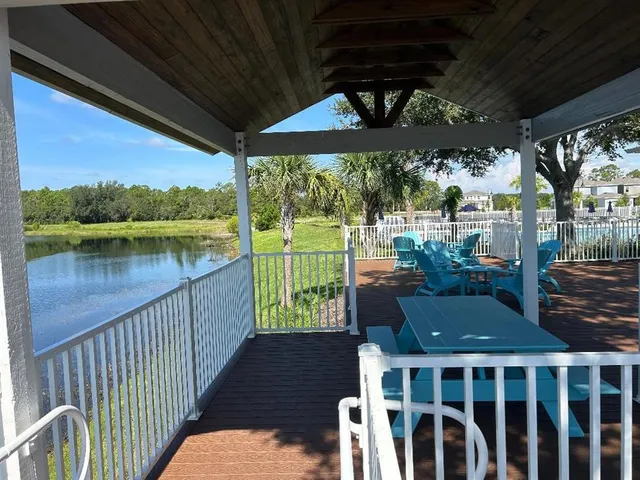 a view of a chairs and table in patio with a lake view