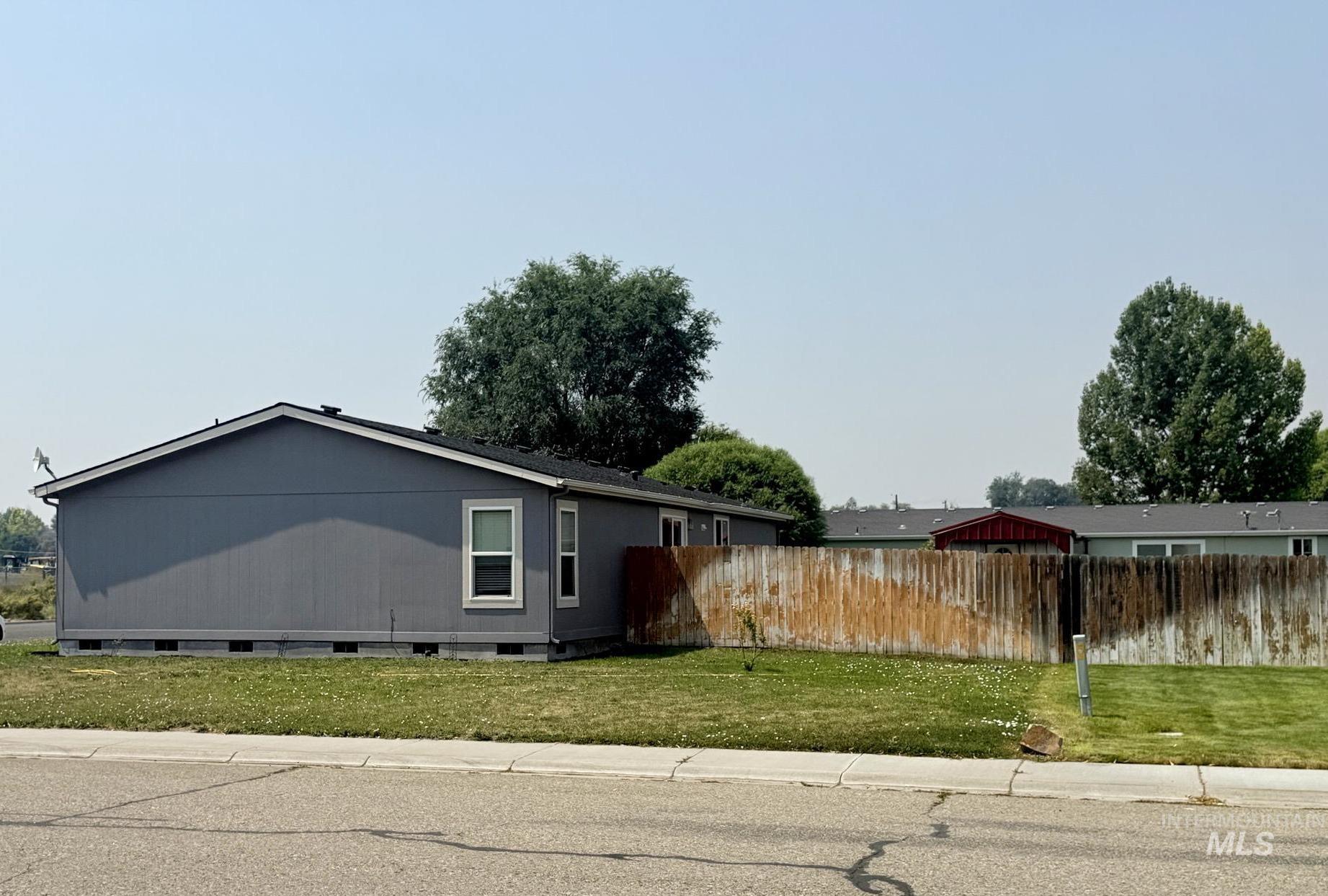 100 Ellsworth Street Vale, OR 97918 - Photo 25 of 25 Exterior featuring gray siding, white-framed windows, and a black shingled roof