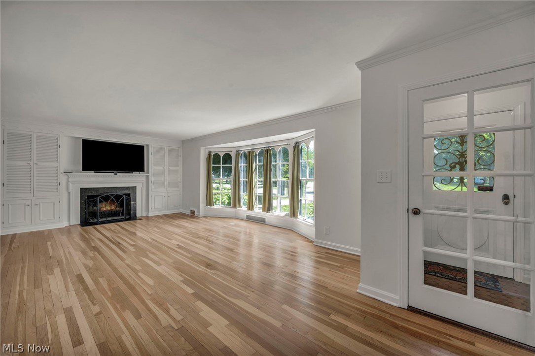3543 Lytle Road Shaker Heights, OH 44122 - Photo 8 of 49 Hardwood flooring extends throughout this expansive room, featuring a bay window with multiple arched panes