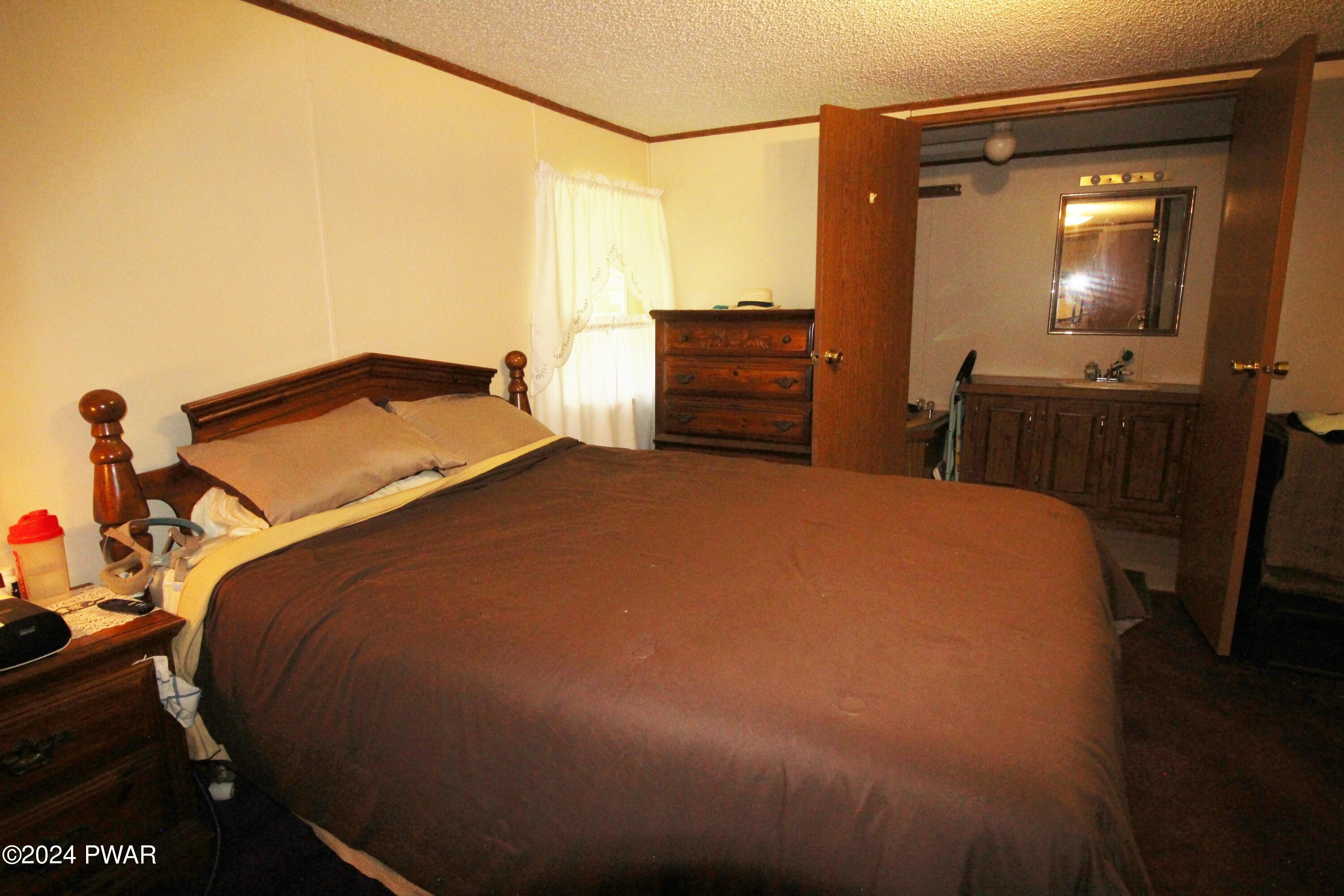 10 Madison Estate Moscow, PA 18444 - Photo 30 of 45 a bed sitting in a bedroom and next to a window