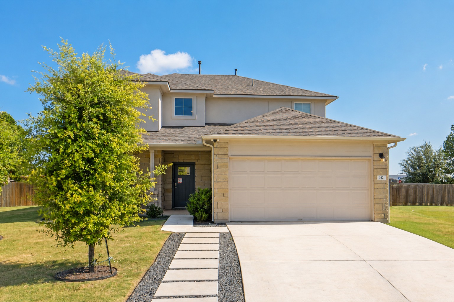 142 Brunnen Way Georgetown, TX 78626 - Photo 1 of 22 A striking modern facade with stone accents and a spacious driveway welcomes you.