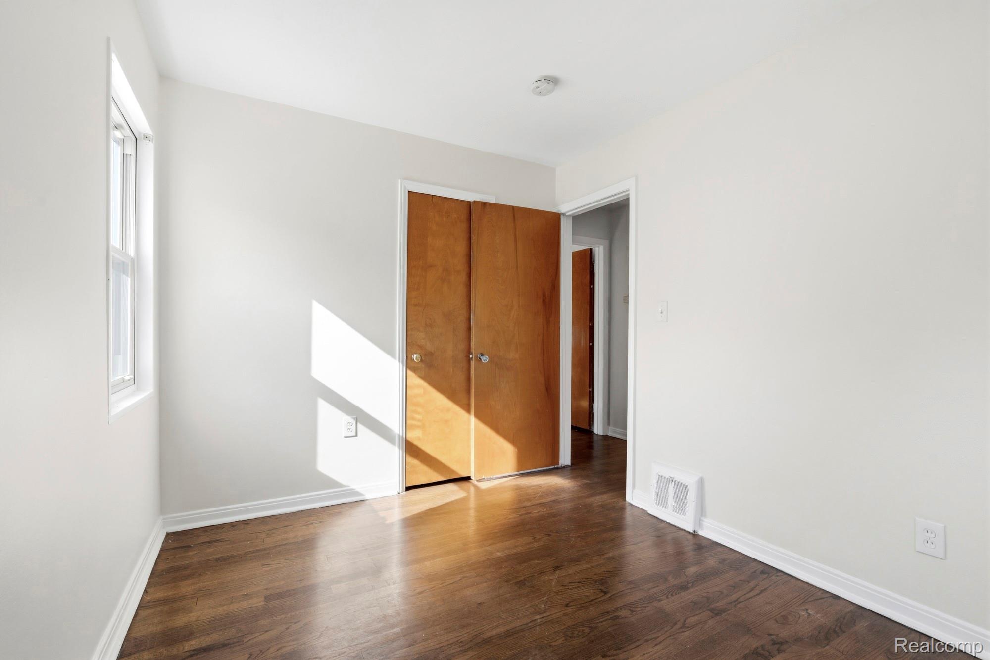 970 Champaign Road Lincoln Park, MI 48146 - Photo 20 of 28 Unfurnished bedroom featuring dark wood-style floors and a closet