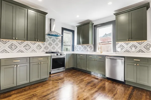 a kitchen with stainless steel appliances granite countertop a sink and cabinets