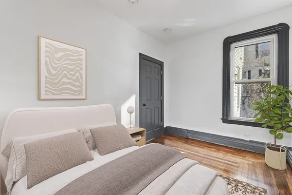 a bedroom with a bed and a window