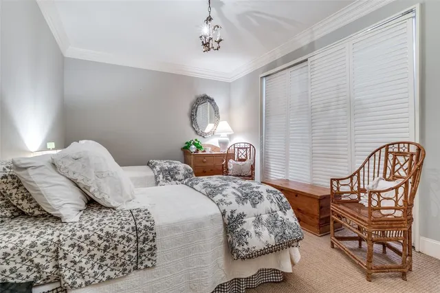 a bedroom with a bed chair and wall painting