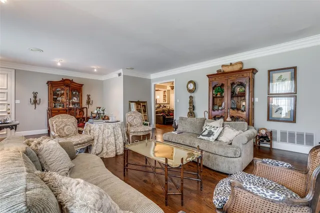 a living room with furniture wooden floor and a window